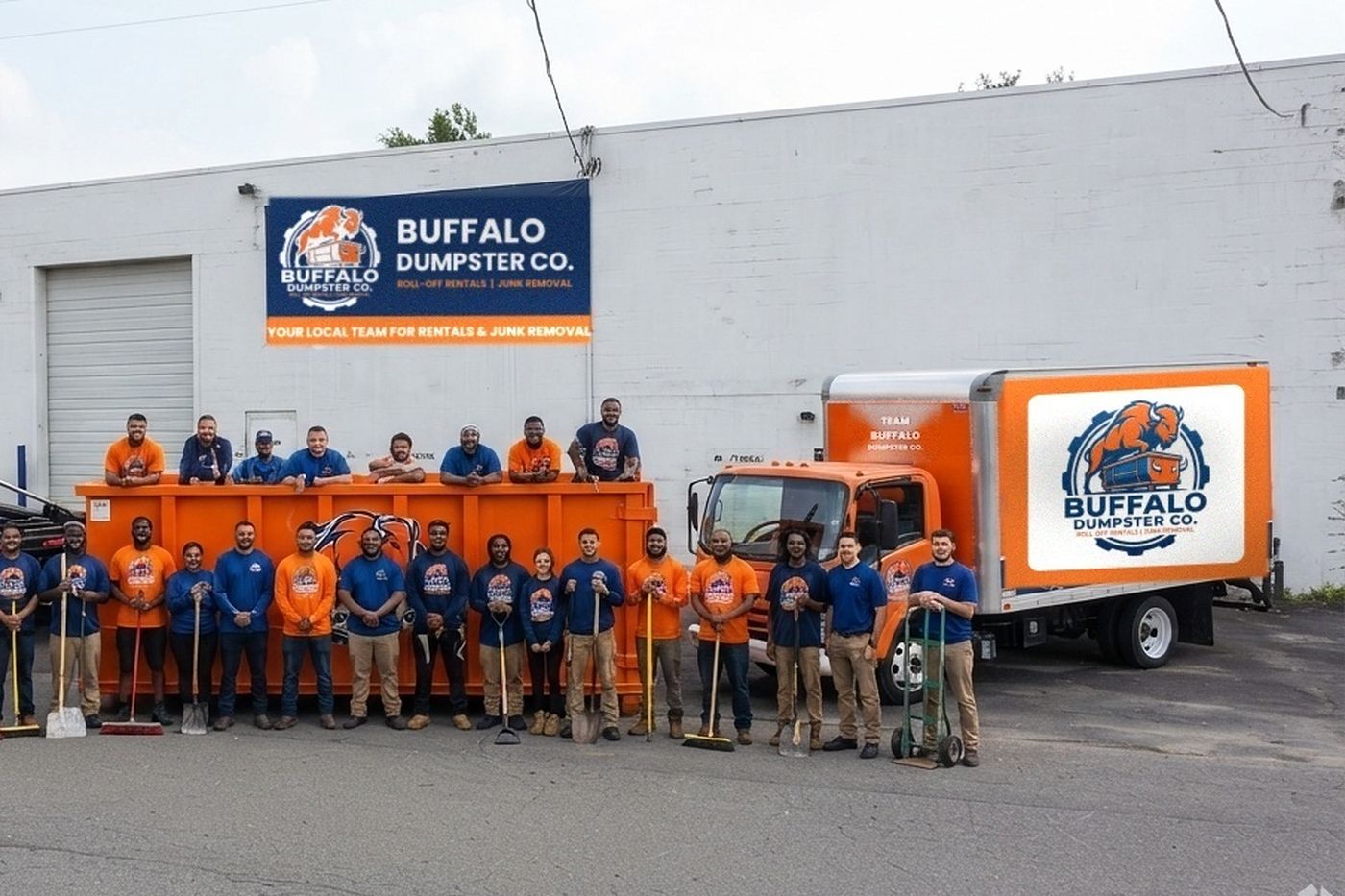 The Buffalo Dumpster Co. crew with brooms, shovels and a hand truck in front of the box truck